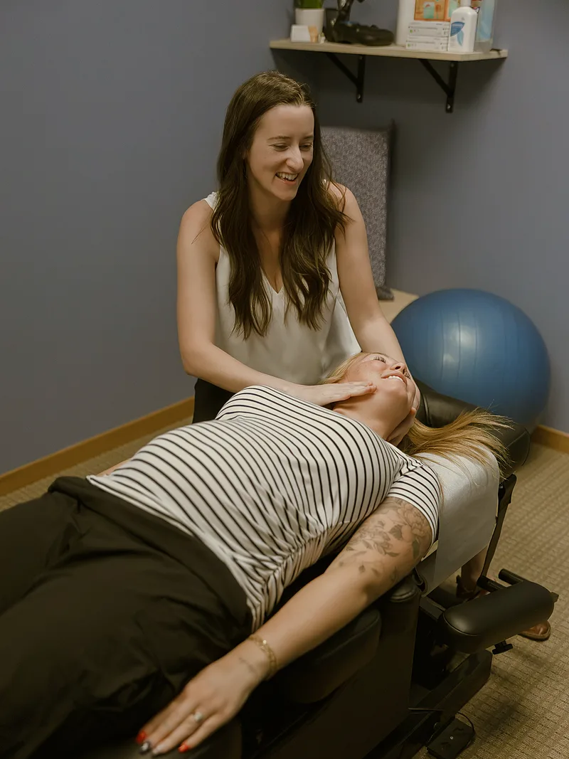 Dr. Moriah performing a gentle neck adjustment on a patient